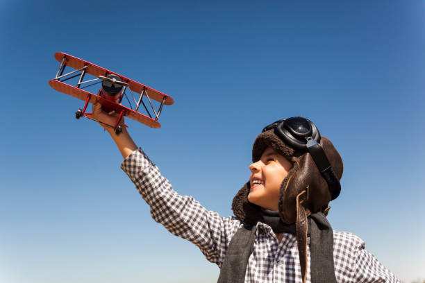 istock Boy playing with toy airplane 842650172