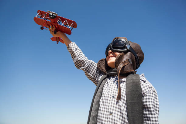 istock Boy playing with toy airplane 842650346