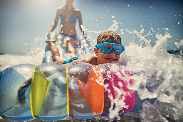 istock Little boy with mother playing having fun in sea 842650348