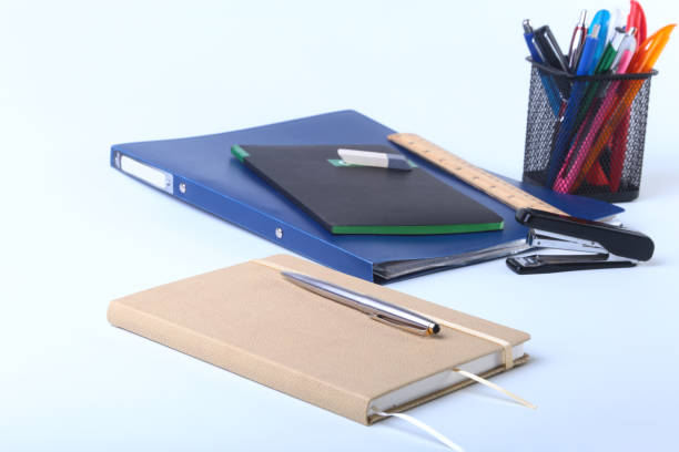 istock Colorful notebooks and office supplies on white table. 842659838