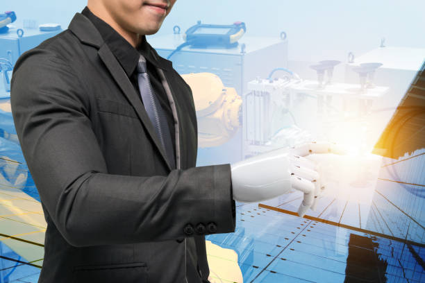 istock Artificial intelligence (ai) robot technology in smart factory concept. Male business suit with robotic hand point finger and double exposure of automation robot industry machine and building. 842660588
