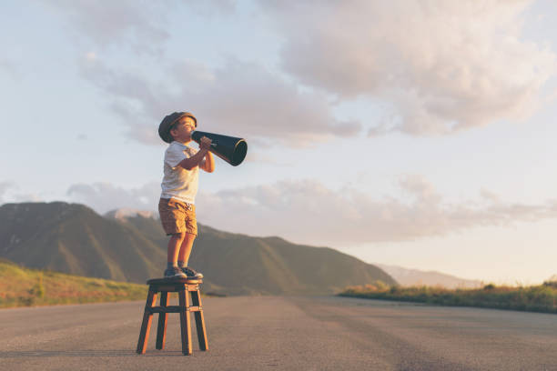 istock Young Boy Salesman Delivers Megaphone Message 842663422