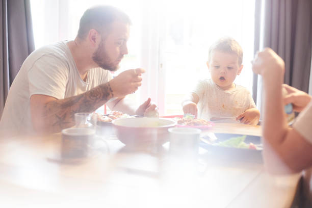 istock Young family having meal time together 842664162