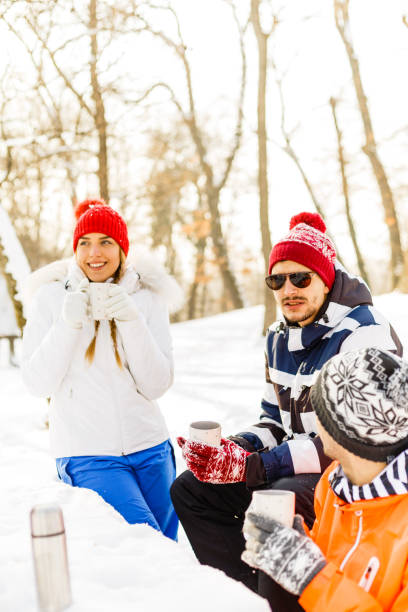 istock Friends drinking hot coffee outdoors in winter day 842677278