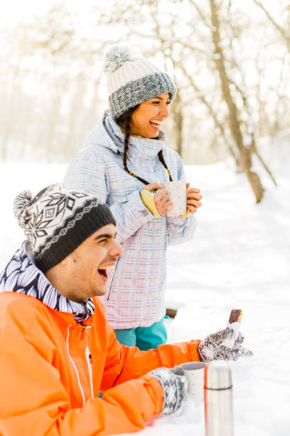 istock Laughing man and woman with hot drinks 842677290