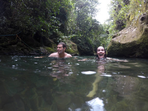 istock Married couple swims in jungle river 842678276