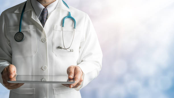 istock Male Doctor Holding Tablet Computer 842678900
