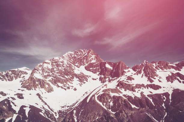 Winter landscape of snow mountain range and blue sky. Scenery background for mountain activities such as skiing, trekking, winter sport and mountain climbing.