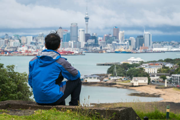 istock Young man looking Auckland city skyline 842679342