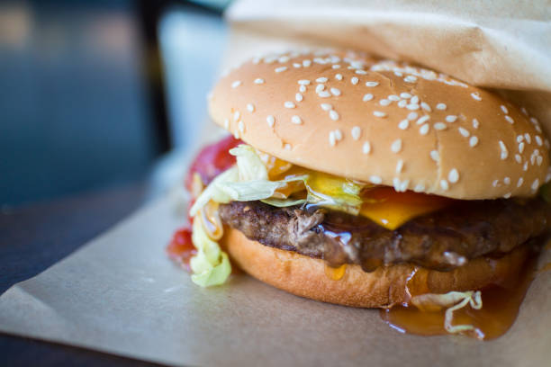 Picture of juicy hamburger with beef and ketchup on the table