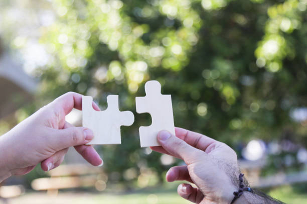 istock business people assembling jigsaw puzzle and represent team support and help concept. Building a business success. Concept for consulting, marketing, business, strategy and planning. 842688988