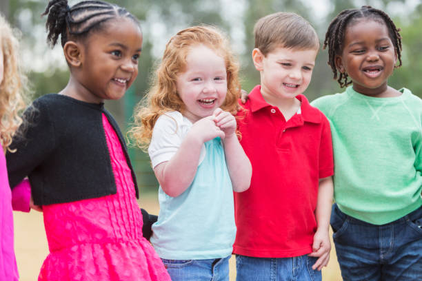 istock Multi-ethnic group of young children standing in the park 842689132