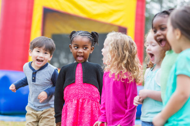 istock Multi-ethnic children shouting, next to bounce house 842689144