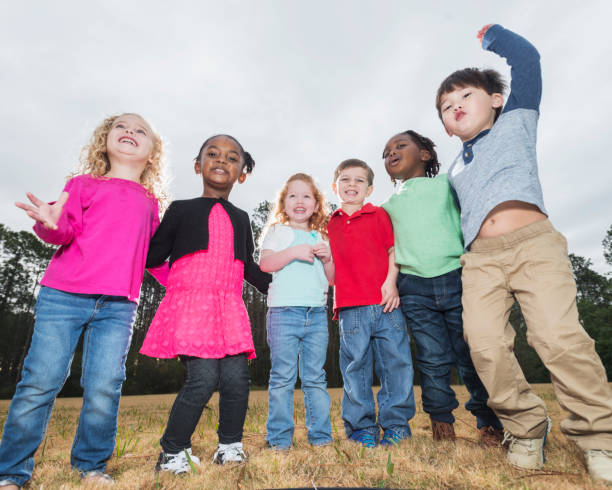 istock Multi-ethnic group of young children standing in a row 842689302