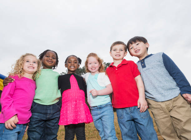 istock Multi-ethnic group of young children standing in a row 842689392