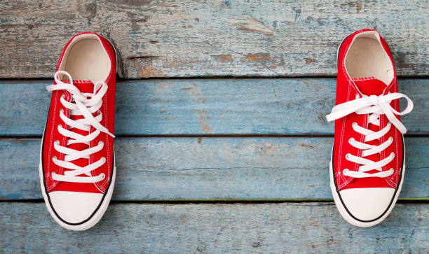 istock Red retro sneakers on a blue wooden background 842689476