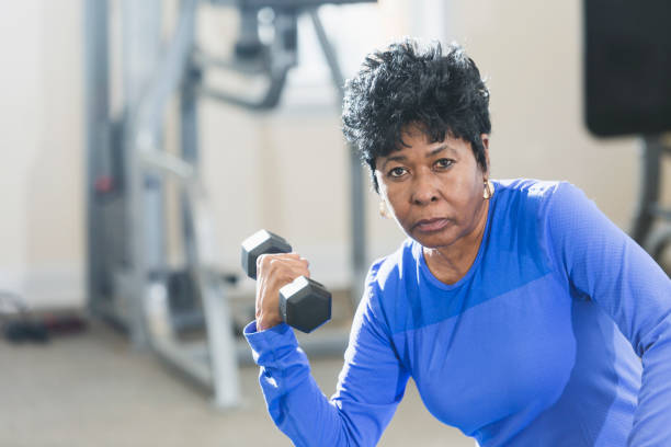 istock Mature black woman exercising at gym 842689540