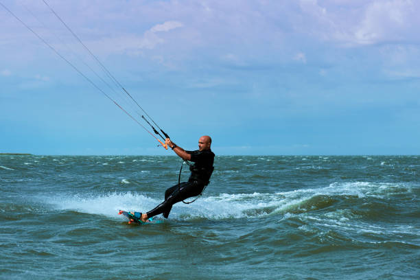 istock Kitesurfing on waves at sea in summer. 842690158