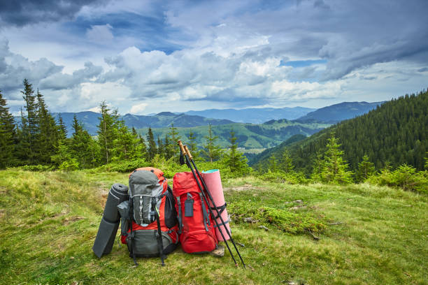 istock Backpacks in the mountains overlooking the mountains on the green grass. 842690174