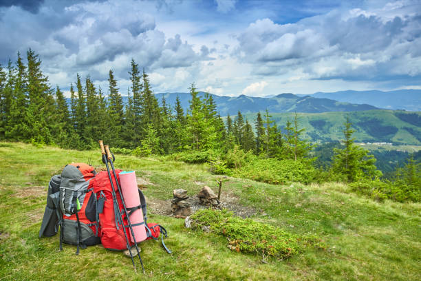 istock Backpacks in the mountains overlooking the mountains on the green grass. 842690184