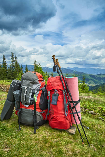istock Backpacks in the mountains overlooking the mountains on the green grass. 842690208