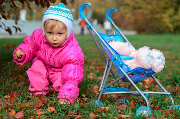 Photo of little girl playing with sidecar