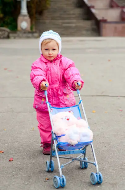 Photo of little girl playing with sidecar