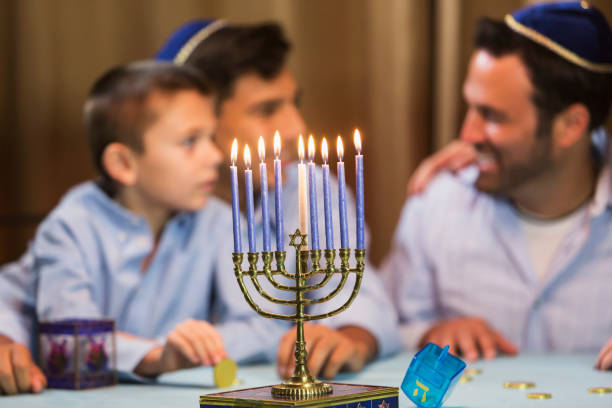 istock Father and sons with menorah 842699194