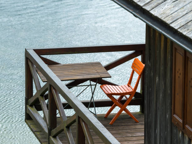 istock An orange chair and a table  standing on a balcony 842714808
