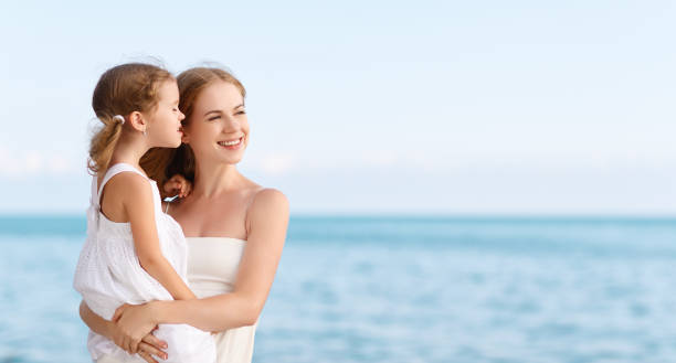 istock happy family at beach. mother hugging child daughter 842723708