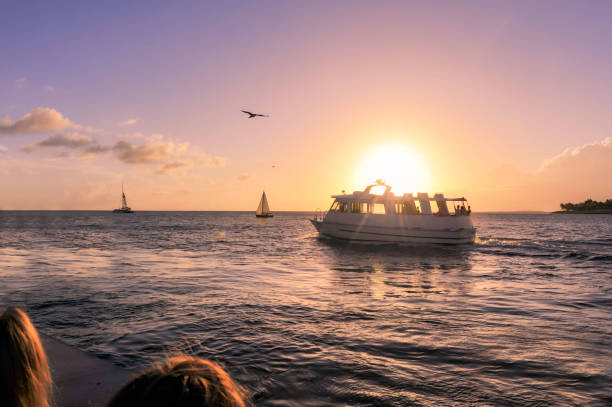 sunset at key west with sailing boat - moody sky water sport passenger craft scenics imagens e fotografias de stock