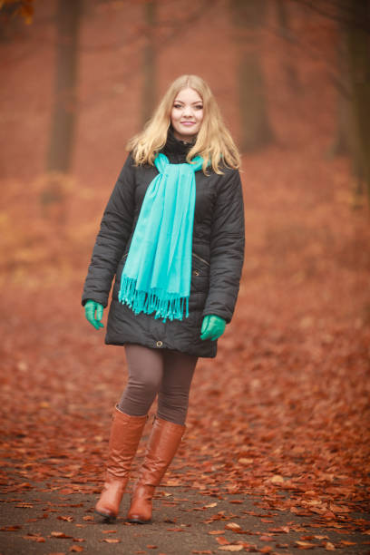 istock Attractive woman in autumnal park. 842726400