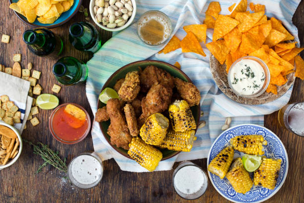 istock Party dinner table concept. Fried chicken, beer and snacks to beer on wooden surface 842726838