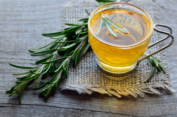 istock Rosemary herbal tea in a glass cup on rustic wooden background. 842727522