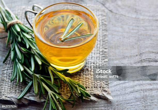 Rosemary Herbal Tea In A Glass Cup On Rustic Wooden Background Stock Photo - Download Image Now