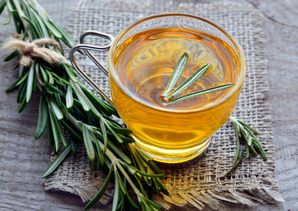 istock Rosemary herbal tea in a glass cup on rustic wooden background. 842727544