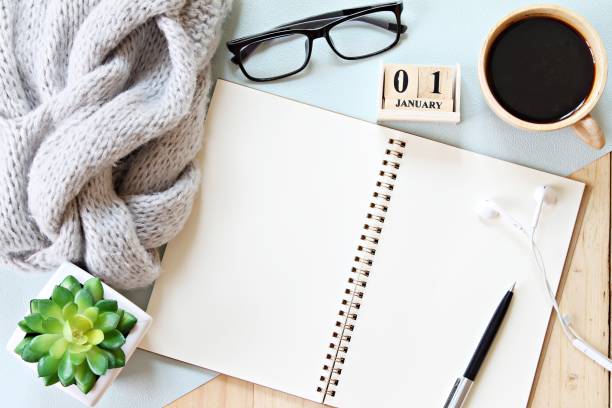 istock Desk table with scarf, notebook paper, accessories, cube calendar and coffee cup, Top view or flat lay with copy space ready for adding or mock up 842732358