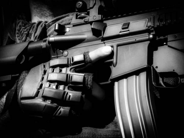 istock Background finger on gun cock closeup black and white 842735720