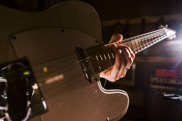 istock Electric guitar in guitarist hands closeup 842747284