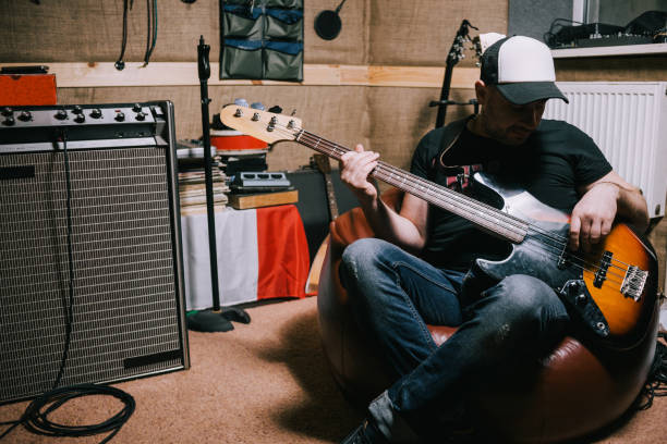 istock Bass guitarist playing guitar in music studio 842747546