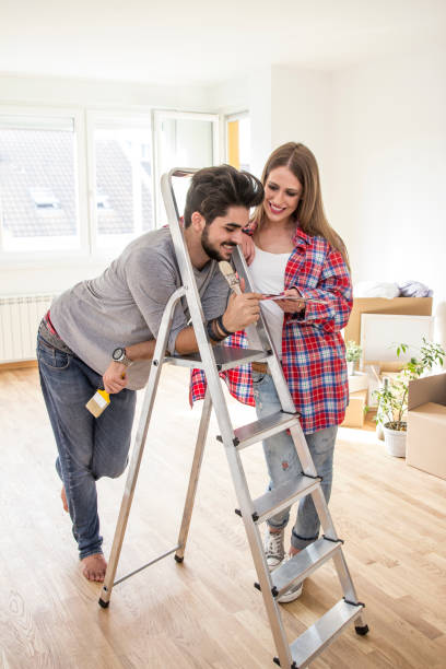 istock Young couple choosing color for paint 842752084