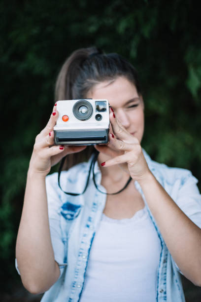 istock Girl making photo with old camera 842756228