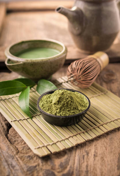istock Matcha fine powdered green tea on wooden background. 842758890
