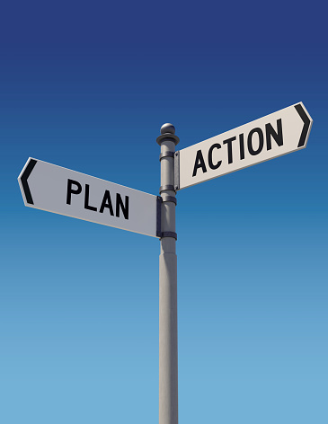 Street signs against clear blue sky pointing opposite directions: Plan and Action. Dilemma and choice concept. Vertical composition with copy space. Clipping path is included.