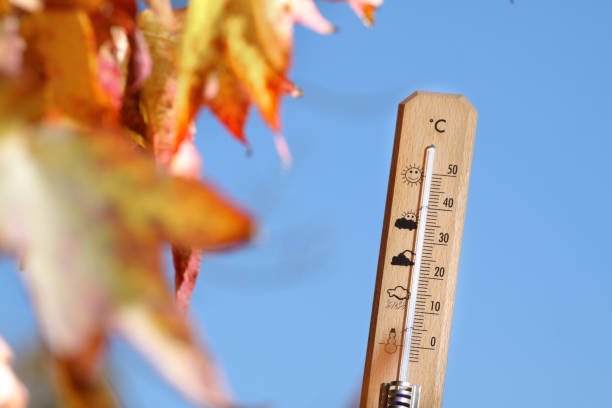 nice weather in the autumn shown with mercury thermometer Image of a thermometer with pretty colors of fall in the background cool climate stock pictures, royalty-free photos & images