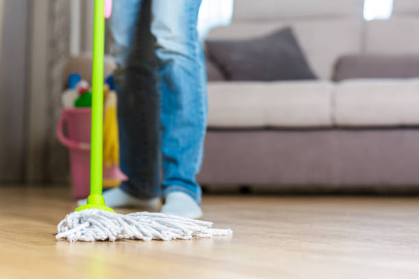 istock woman in protective gloves using a wet-mop while cleaning floor 842767308