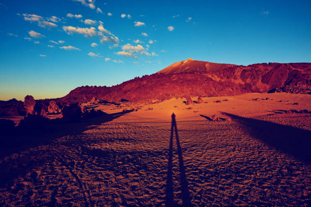 horizontal shot of morning time in Tenerife, unrecognizable man shadow on the ground.
