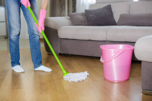 istock woman in protective gloves using a wet-mop while cleaning floor 842768512