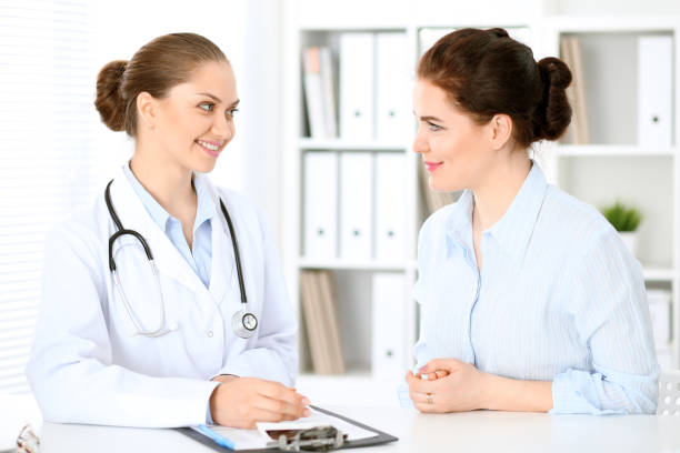 istock Friendly smiling doctor  and  patient sitting at the table 842769130