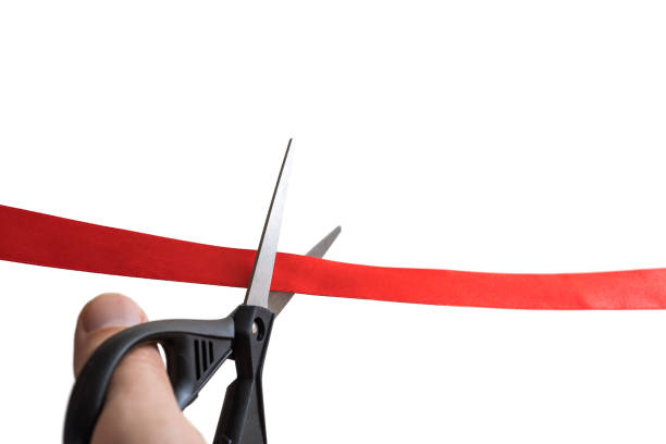 istock Scissors are cutting red ribbon. Opening event concept. Isolated on white background. 842772240